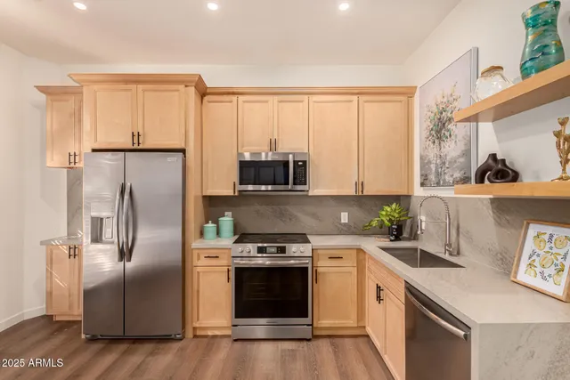 a kitchen with a refrigerator sink and stove top oven