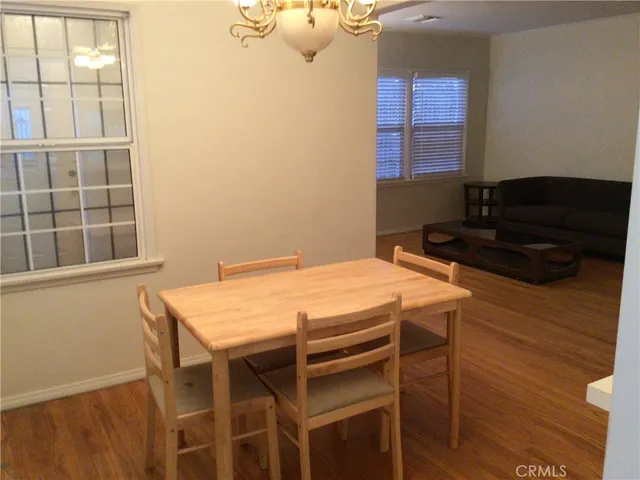 a kitchen with stainless steel appliances a refrigerator a stove and white cabinets