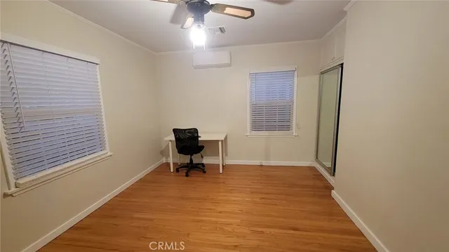 a view of a room with wooden floor and furniture