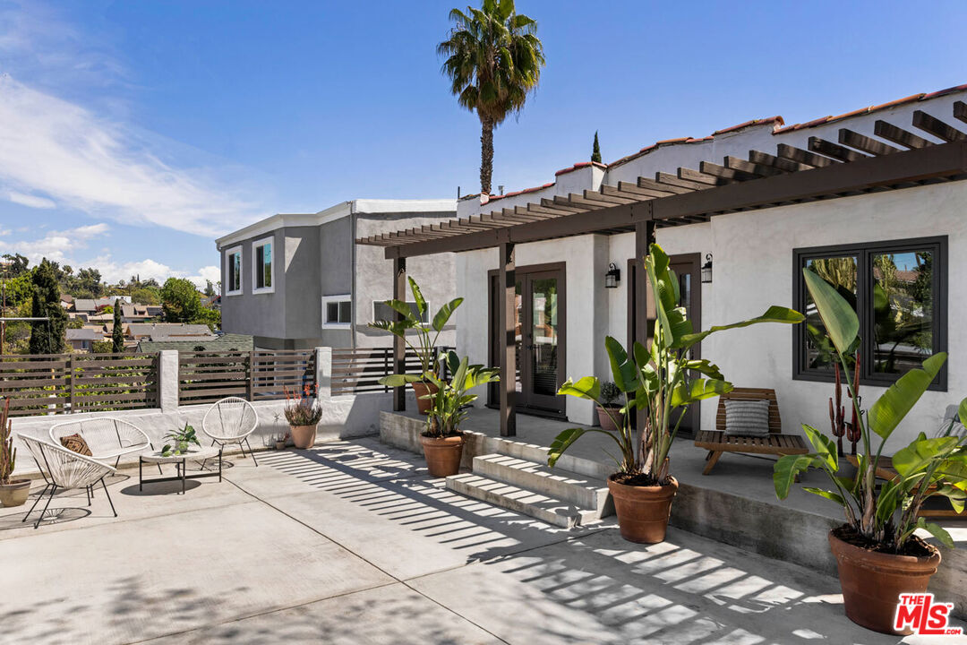 4876 Eldred Street Los Angeles, CA 90042 - Photo 1 of 1 a view of a patio with table and chairs potted plants