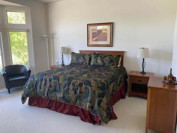 a bed sitting in a bedroom next to a window