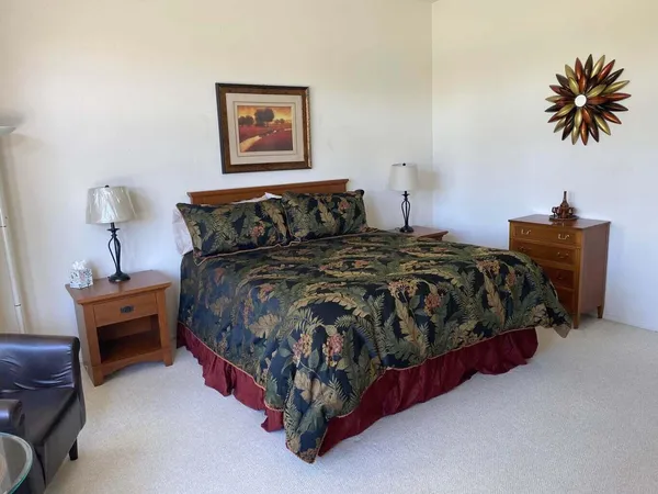 a bedroom with a bed and a table
