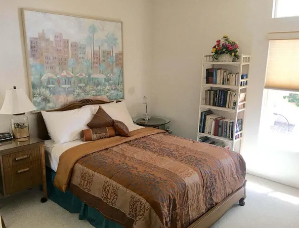 a bed sitting in a bedroom next to a window