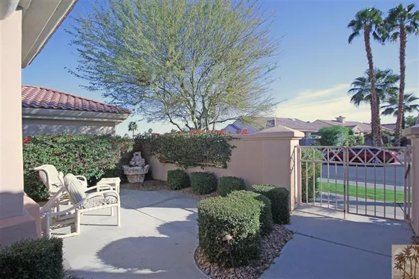 a view of a chairs and table in backyard