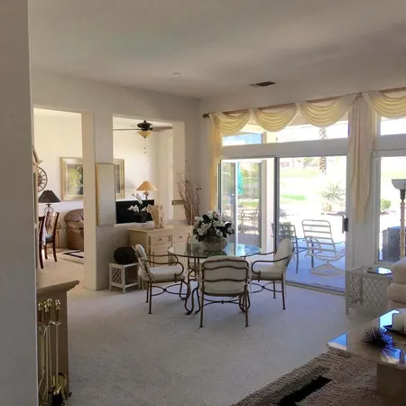 a living room with furniture and a floor to ceiling window