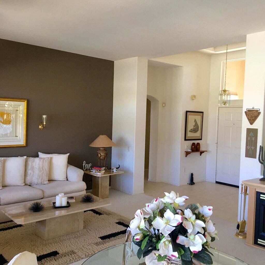 78786 Gorham Lane Palm Desert, CA 92211 - Photo 8 of 26 a living room with furniture flowerpot and a chandelier