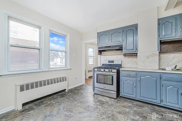 a view of a refrigerator in kitchen and window