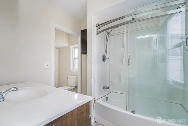 a bathroom with a toilet a sink and a window