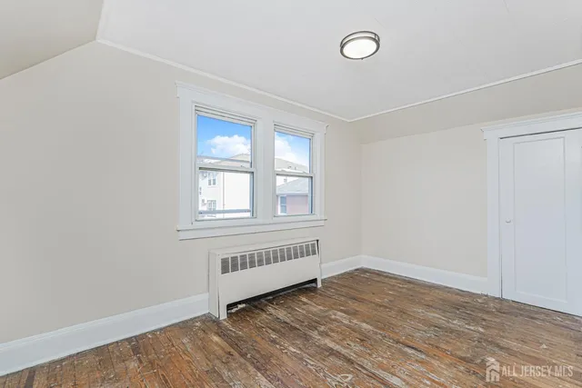 a view of a room with wooden floor