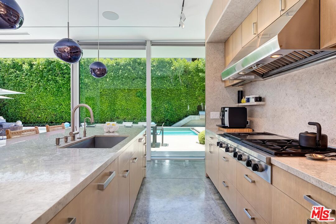 1342 Appleton Way Venice, CA 90291 - Photo 17 of 46 a kitchen with a stove a sink and a wooden cabinets
