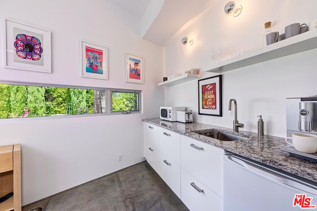 1342 Appleton Way Venice, CA 90291 - Photo 44 of 46 a bathroom with a granite countertop sink and a large mirror