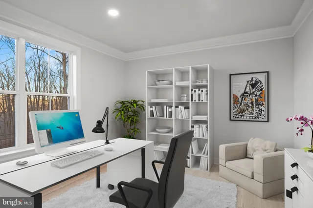 a view of an empty room with windows and wooden floor