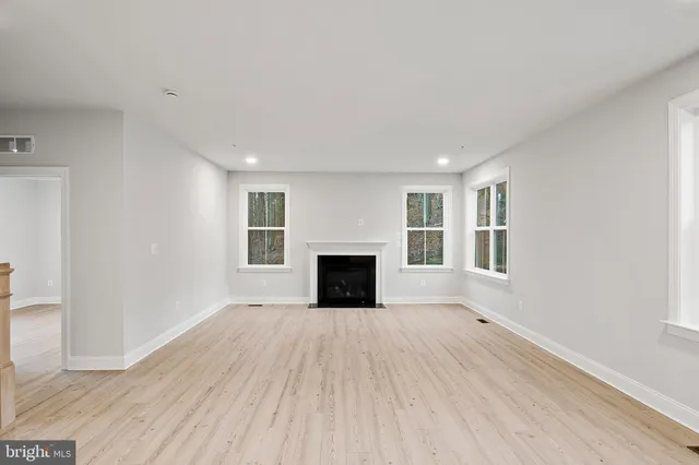 a kitchen with stainless steel appliances granite countertop white cabinets a sink and a stove