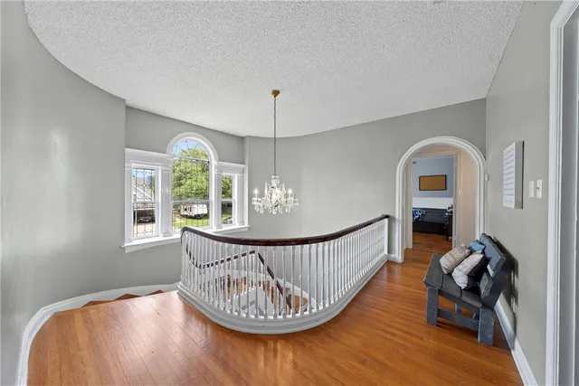 a view of a livingroom with furniture hardwood floor and windows