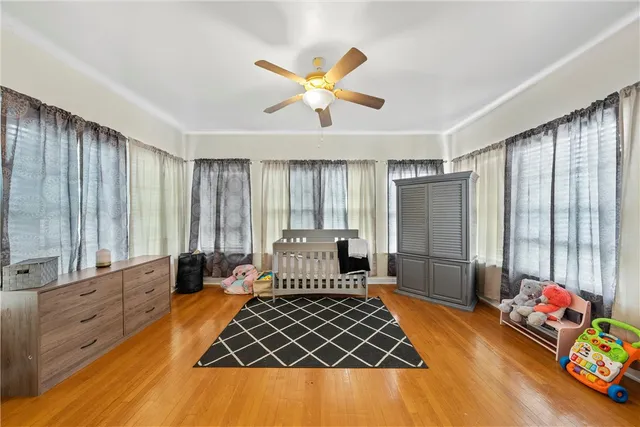 a bedroom with furniture and a large window