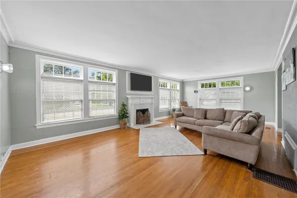 a living room with furniture and a fireplace