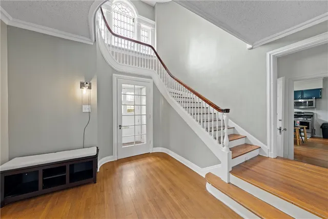 a view of a livingroom with wooden floor and stairs
