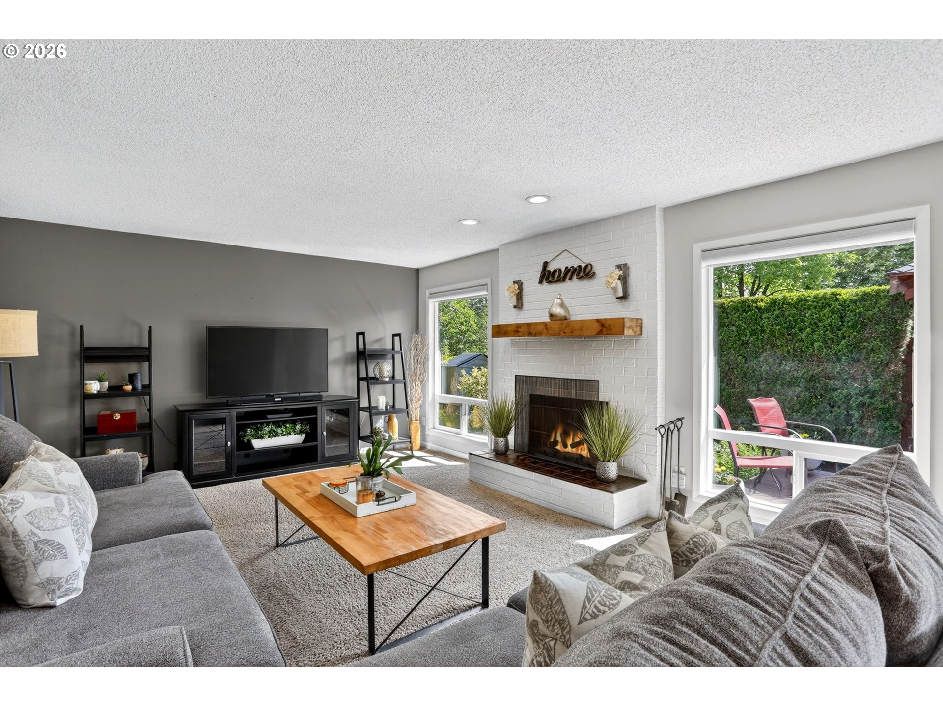 1776 Southeast 114th Place Portland, OR 97216 - Photo 21 of 47 a living room with furniture a flat screen tv and a fireplace