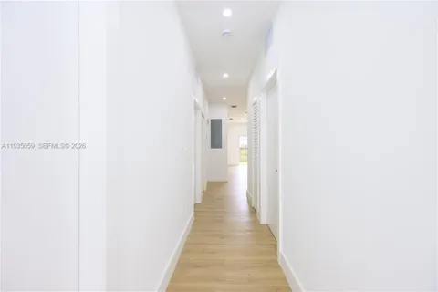 a view of a hallway with wooden floor