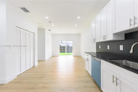 a kitchen with stainless steel appliances granite countertop a sink and a stove