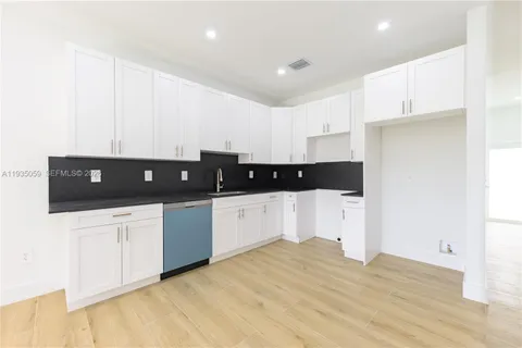 a view of a kitchen with electric appliances