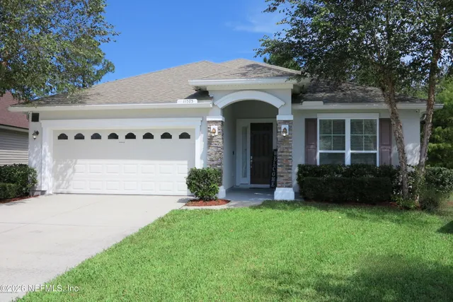 a front view of a house with a yard and garage
