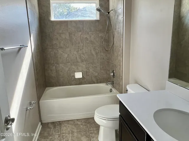 a large tree in front of a house