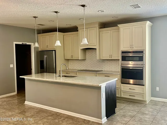 a spacious bathroom with a double vanity sink a mirror and a bathtub