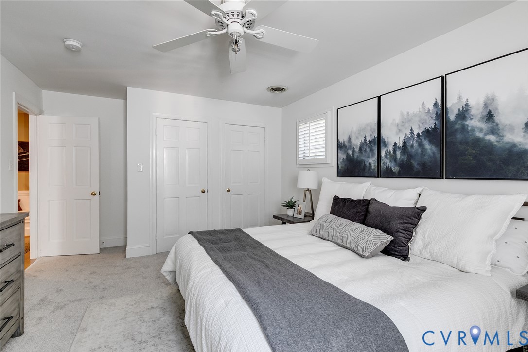 509 Wadeward Road Henrico, VA 23229 - Photo 31 of 59 a bedroom with a large bed and a chandelier
