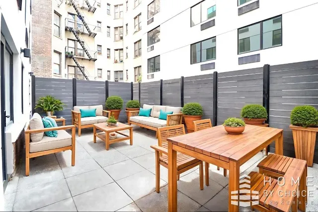 a view of a patio with couches and table and chairs and potted plants
