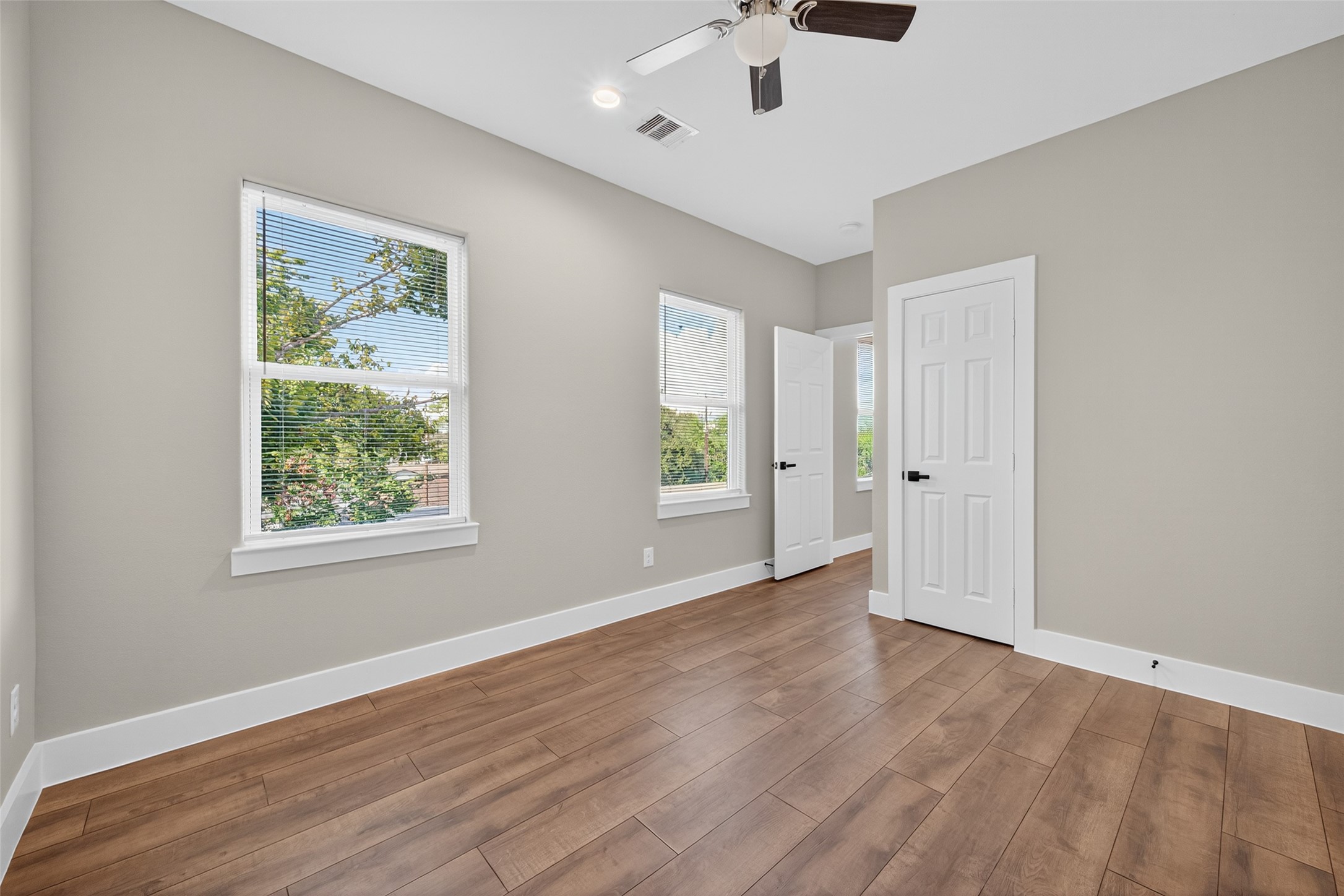 2109 Marnel Road, Unit H Houston, TX 77055 - Photo 11 of 30 a view of an empty room with wooden floor and a window