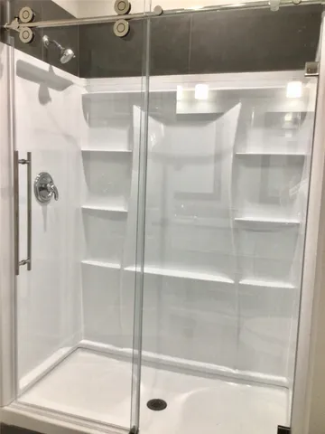 a bathroom with a glass shower door