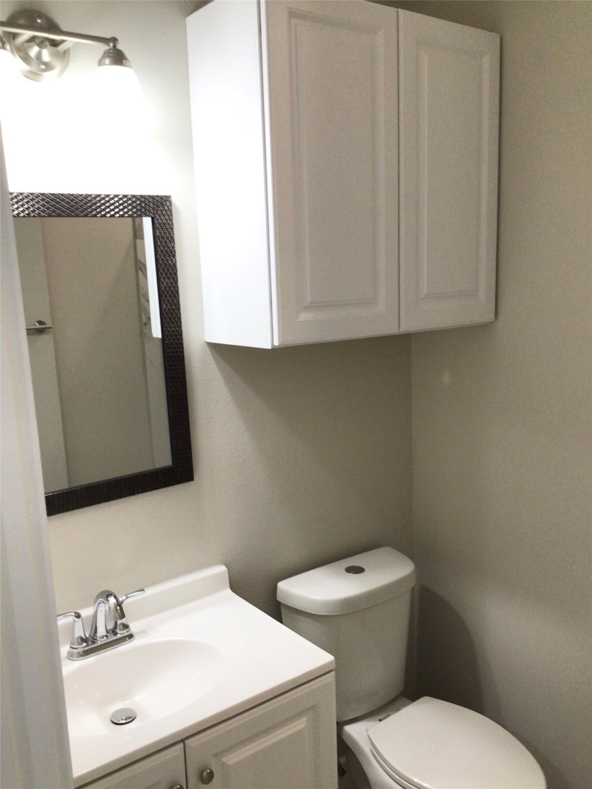 2109 Marnel Road, Unit H Houston, TX 77055 - Photo 20 of 30 a bathroom with a toilet sink and mirror