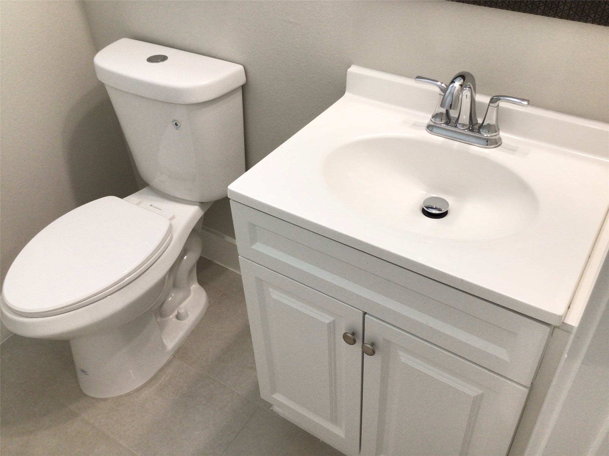 2109 Marnel Road, Unit H Houston, TX 77055 - Photo 21 of 30 a white toilet sitting next to a bathroom sink