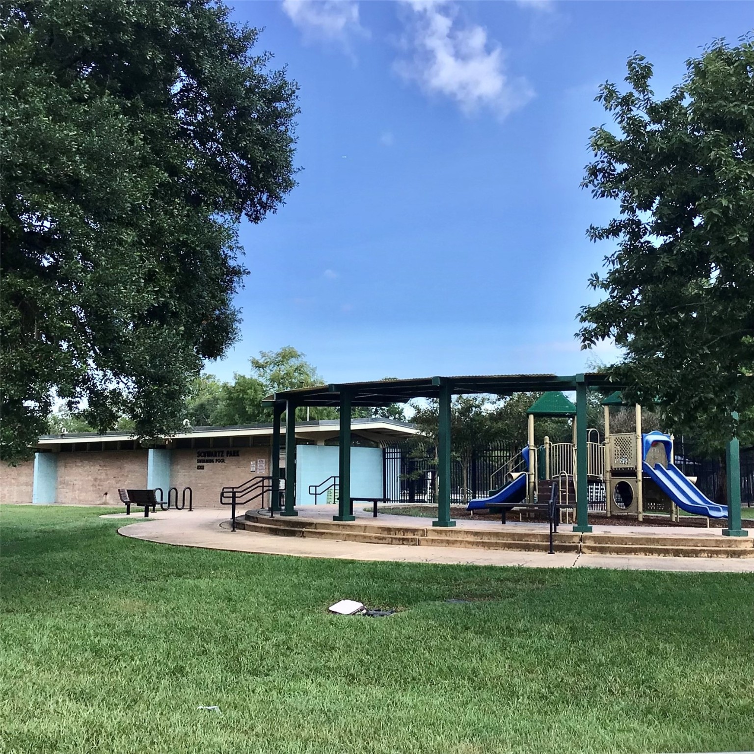 2109 Marnel Road, Unit H Houston, TX 77055 - Photo 27 of 30 a view of a swimming pool with lawn chairs and a small yard