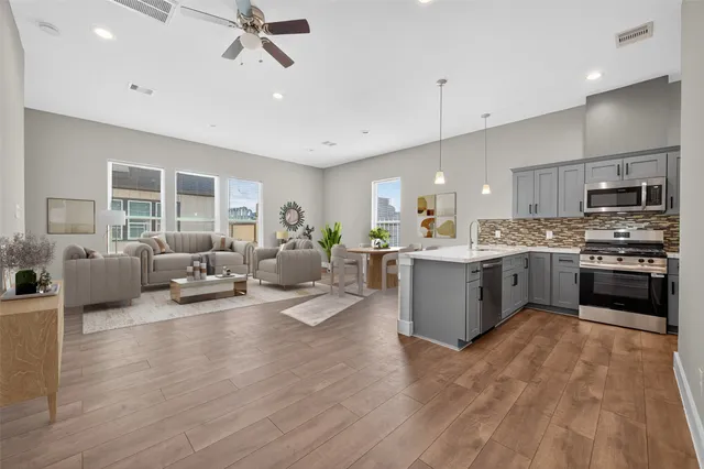 a kitchen with stainless steel appliances granite countertop lots of counter top space