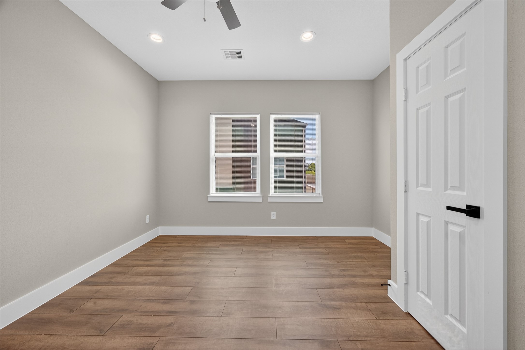 2109 Marnel Road, Unit H Houston, TX 77055 - Photo 10 of 30 an empty room with wooden floor and windows