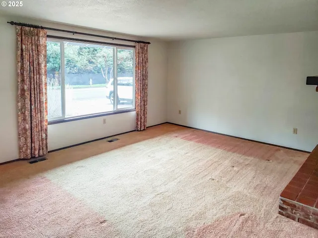 an empty room with a empty space and windows