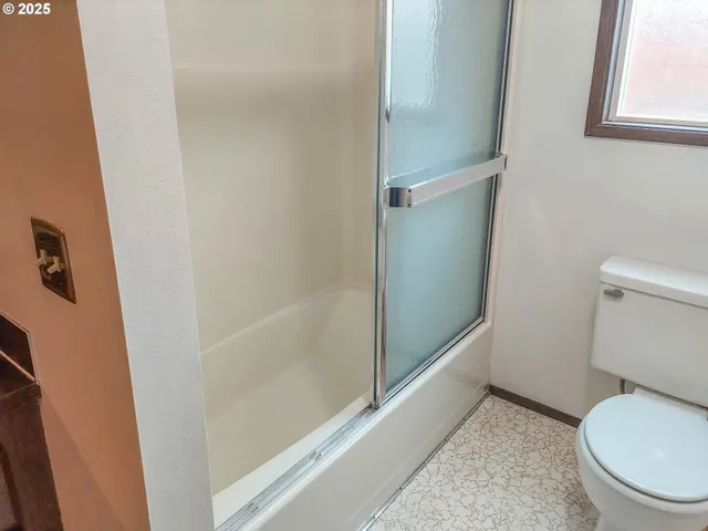 a view of a bedroom with wooden floor