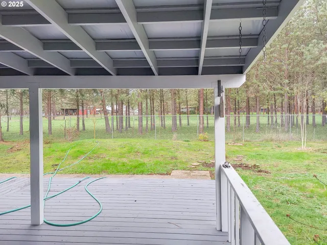 a view of a house with a swimming pool and a yard