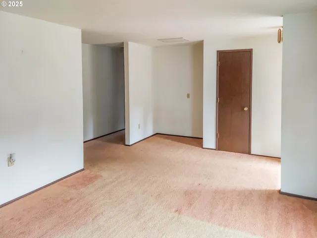 an empty room with closet and mirror