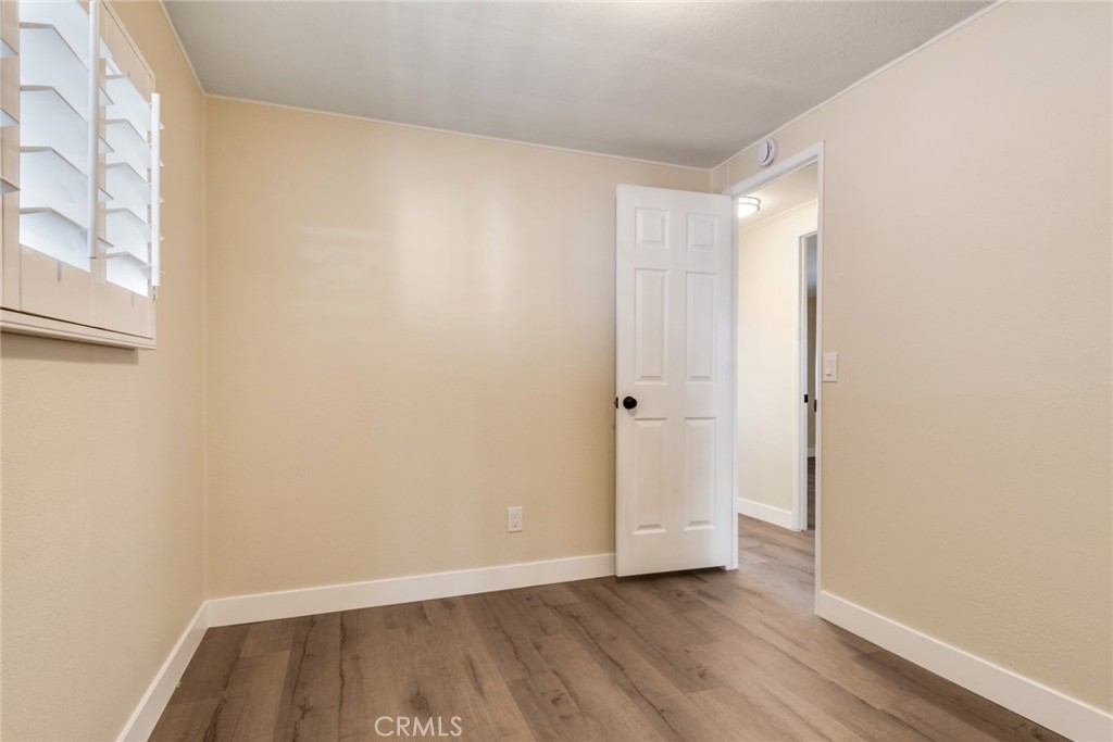 10210 Base Line Road, Unit 115 Rancho Cucamonga, CA 91701 - Photo 12 of 23 a view of an empty room and wooden floor