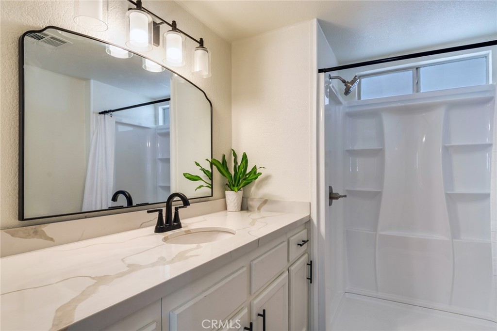 10210 Base Line Road, Unit 115 Rancho Cucamonga, CA 91701 - Photo 15 of 23 a bathroom with a sink and a mirror