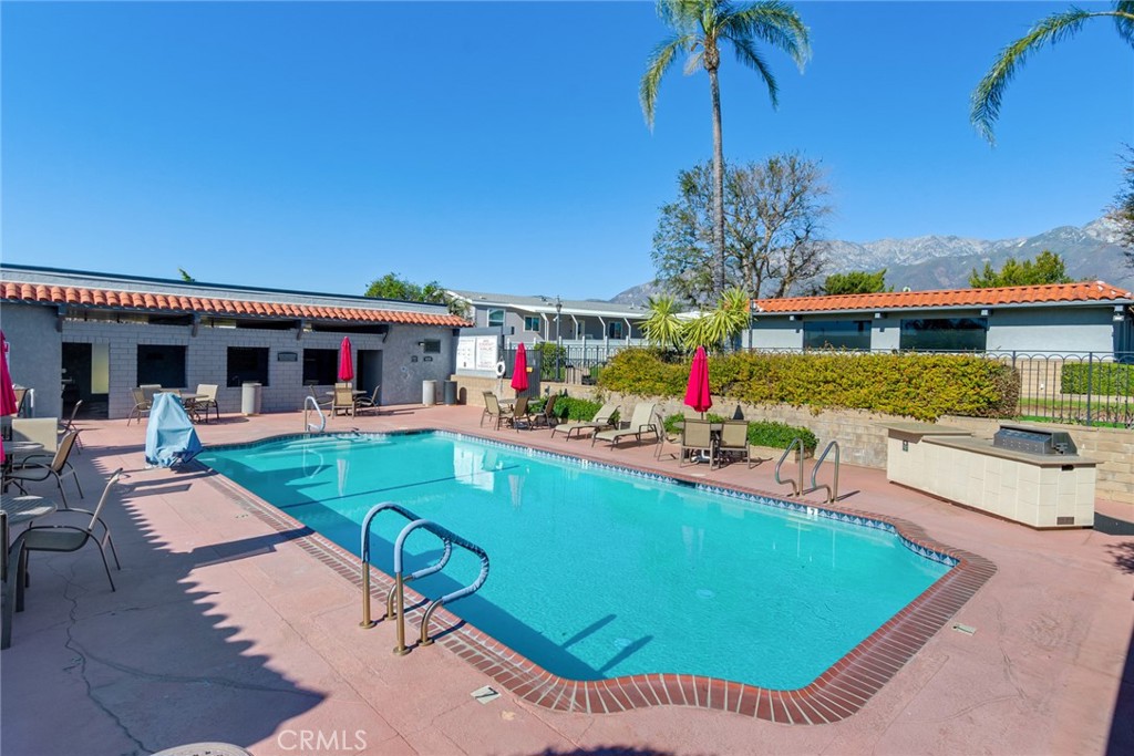 10210 Base Line Road, Unit 115 Rancho Cucamonga, CA 91701 - Photo 22 of 23 a view of a house with swimming pool and sitting area