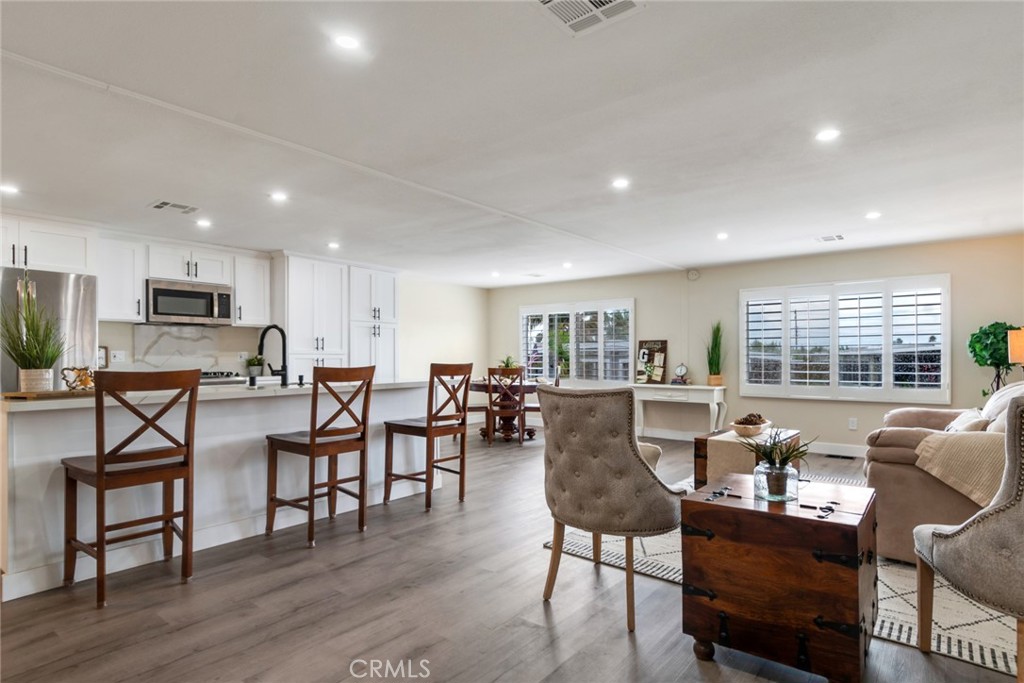 10210 Base Line Road, Unit 115 Rancho Cucamonga, CA 91701 - Photo 5 of 23 a living room with furniture dining table and a large window