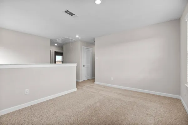 an empty room with a kitchen