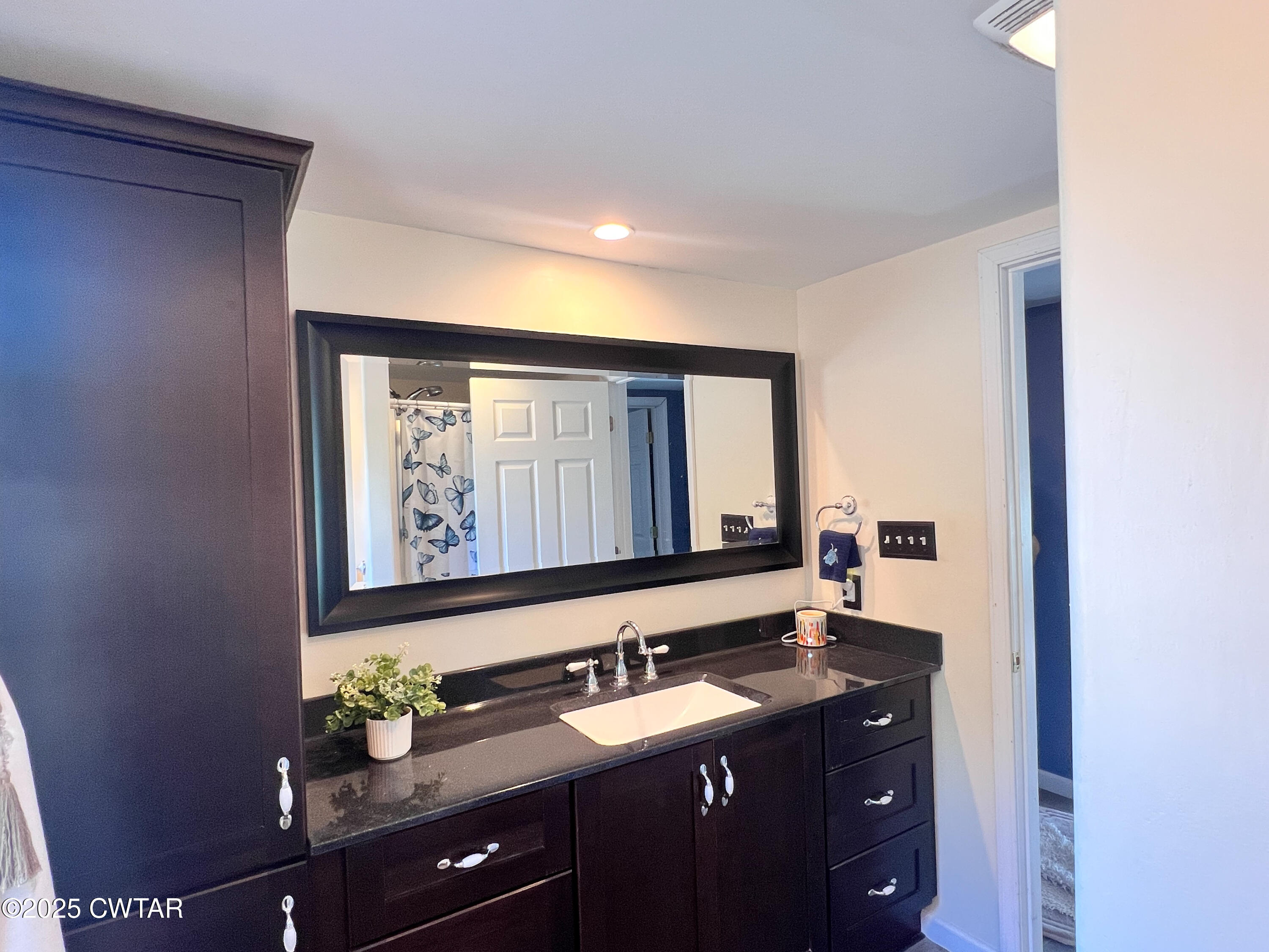 154 North Winchester Street McKenzie, TN 38201 - Photo 11 of 24 a bathroom with a sink vanity and mirror