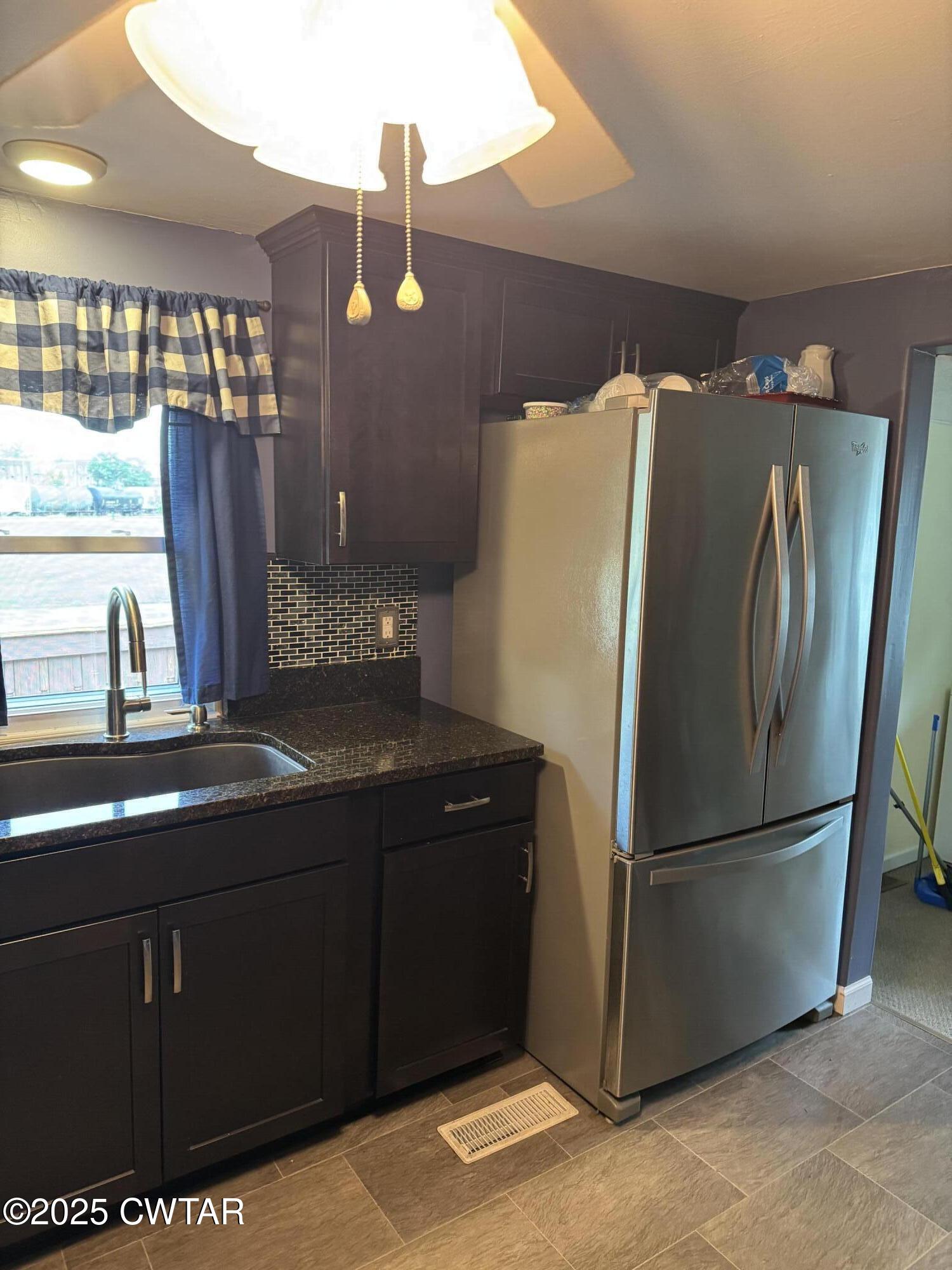 154 North Winchester Street McKenzie, TN 38201 - Photo 17 of 24 a kitchen with stainless steel appliances granite countertop a refrigerator and a sink