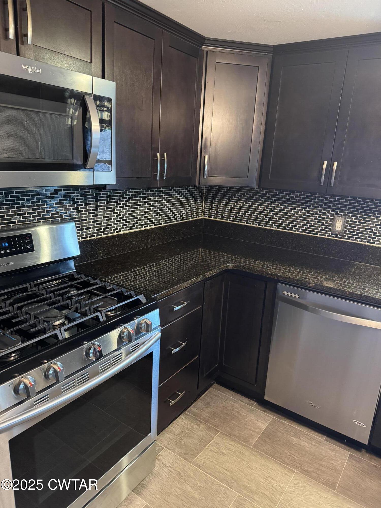 154 North Winchester Street McKenzie, TN 38201 - Photo 20 of 24 a kitchen with granite countertop stainless steel appliances and cabinets