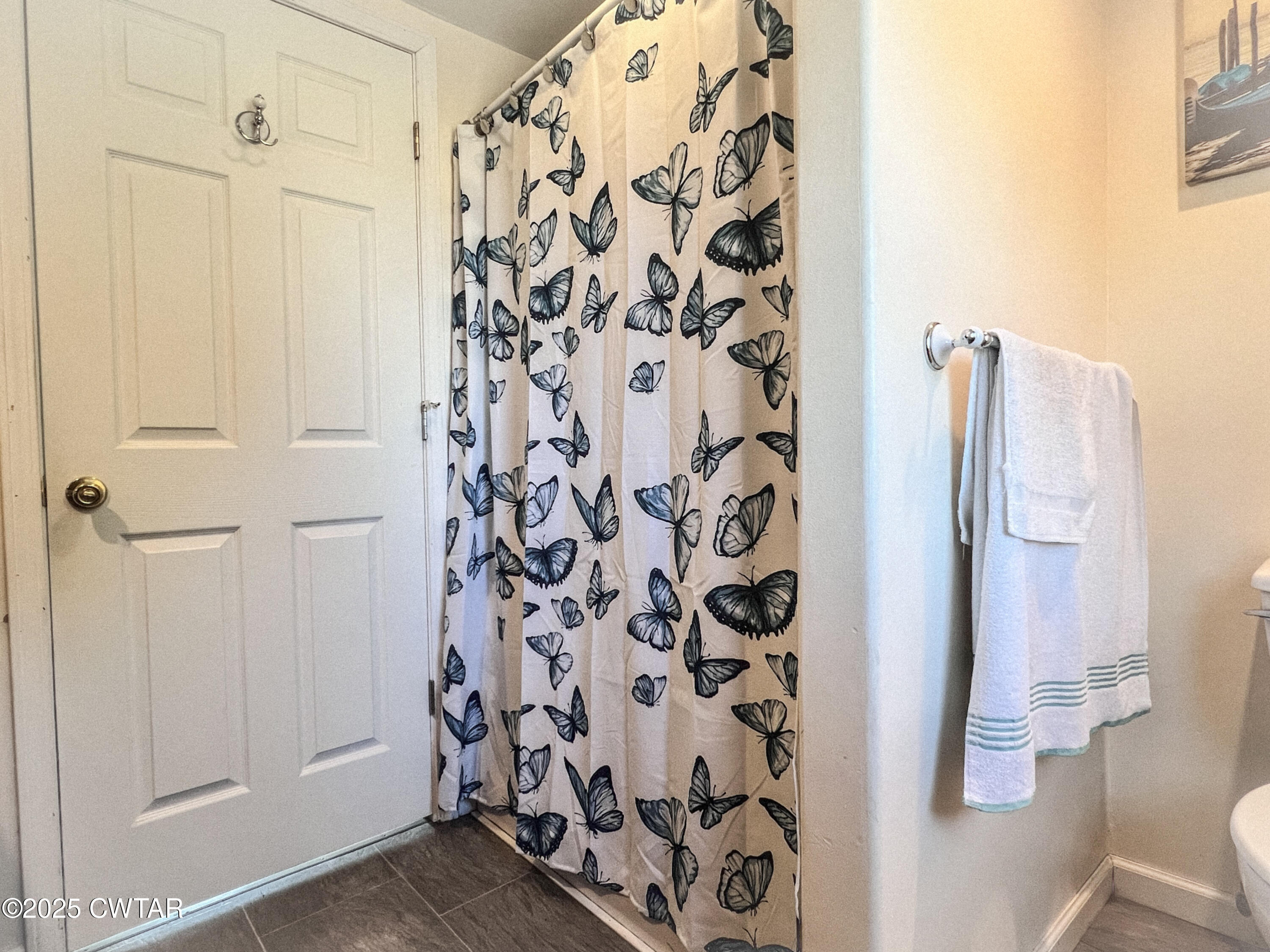 154 North Winchester Street McKenzie, TN 38201 - Photo 9 of 24 a bathroom with a shower curtain and a curtain